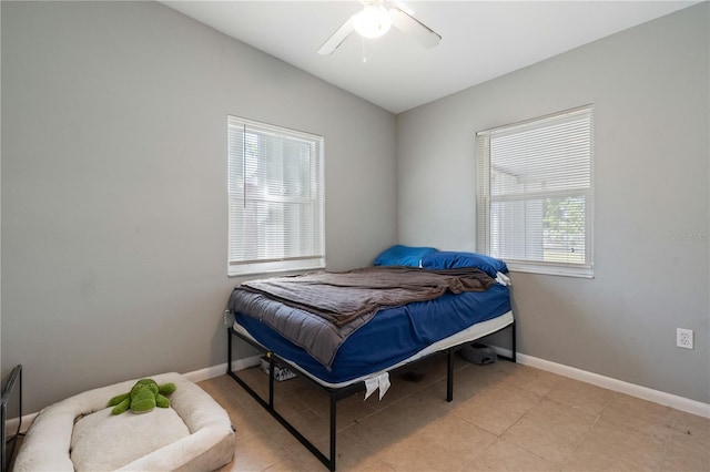 bedroom with a ceiling fan and baseboards