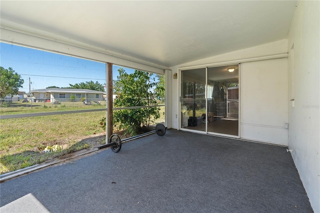 unfurnished sunroom with lofted ceiling