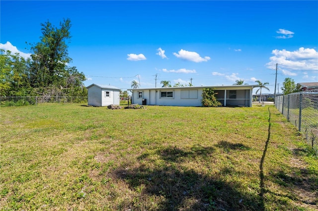 rear view of property with a storage shed, a fenced backyard, a lawn, and an outdoor structure