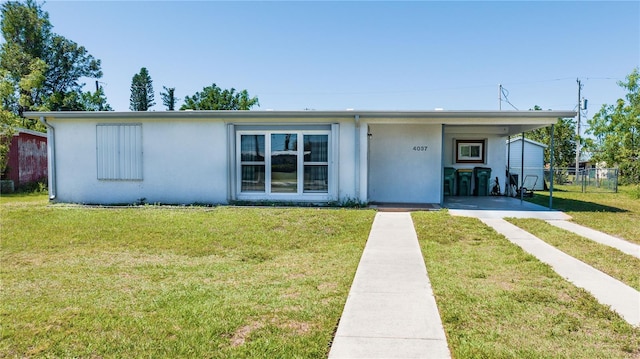 ranch-style house with stucco siding, a front lawn, and fence