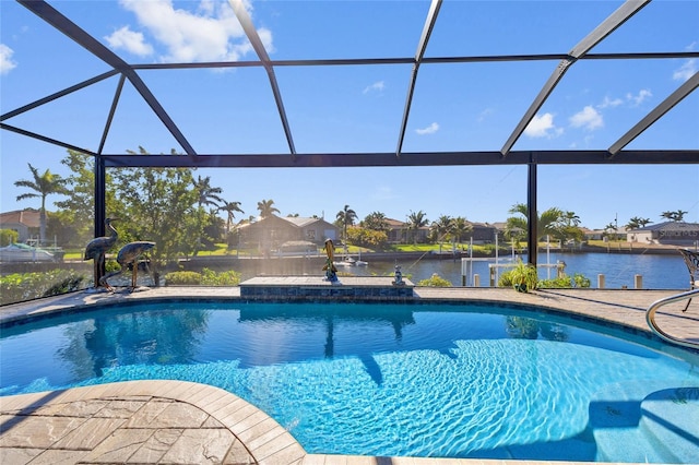 pool with glass enclosure, a water view, and a patio