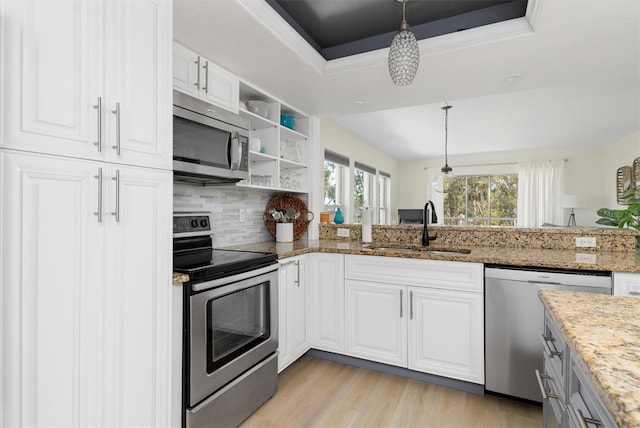 kitchen featuring a sink, open shelves, white cabinetry, stainless steel appliances, and a raised ceiling