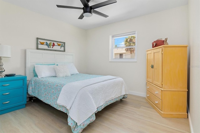 bedroom with baseboards, ceiling fan, and light wood finished floors