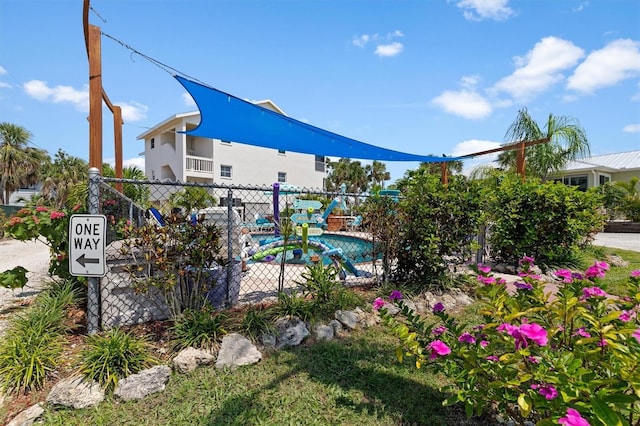 surrounding community with a pool and fence