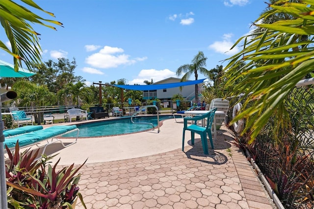 pool featuring a patio area and fence