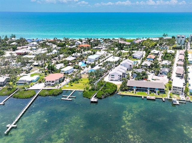 drone / aerial view featuring a water view and a residential view