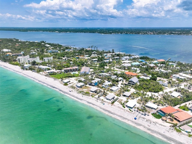 birds eye view of property with a water view and a view of the beach