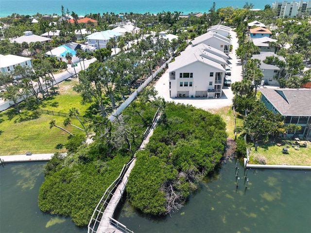 bird's eye view featuring a water view and a residential view