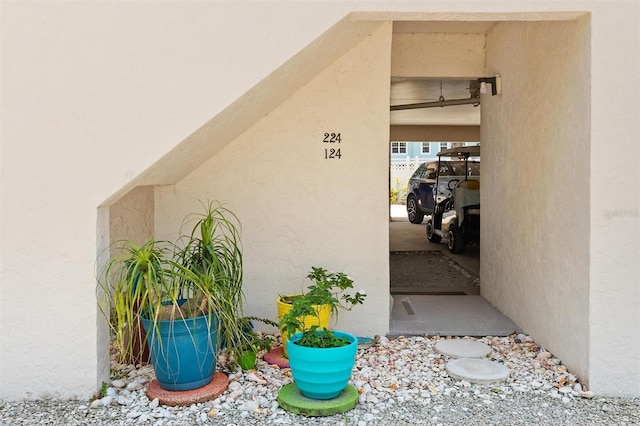 doorway to property with stucco siding