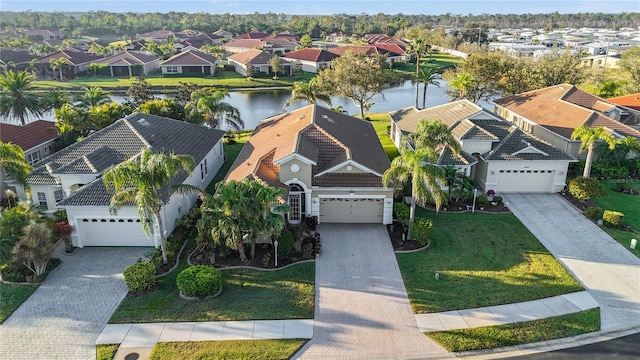 bird's eye view featuring a residential view and a water view