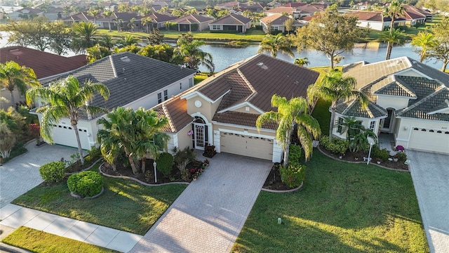 birds eye view of property featuring a residential view and a water view