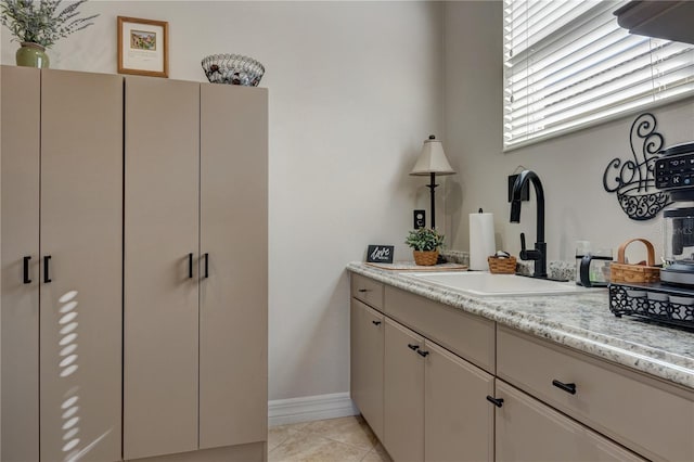 bathroom with tile patterned flooring, vanity, and baseboards