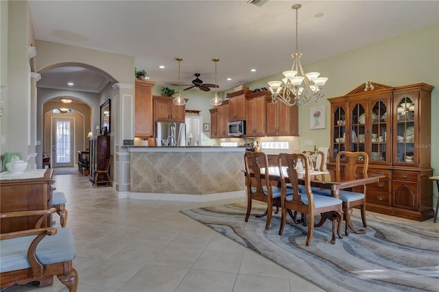 dining space featuring visible vents, recessed lighting, ceiling fan with notable chandelier, light tile patterned flooring, and arched walkways