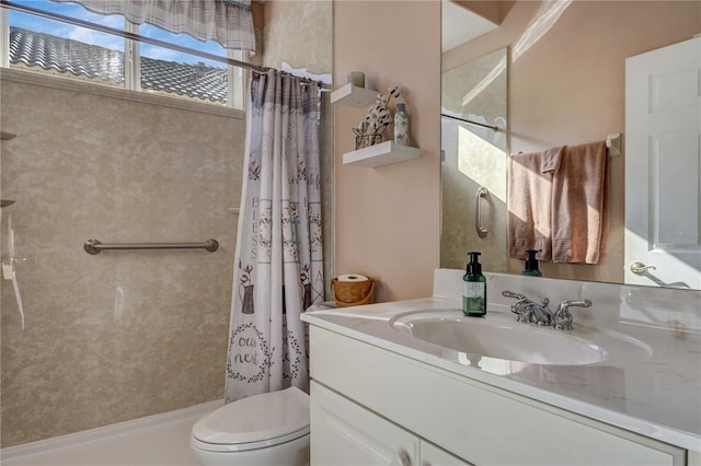 bathroom with toilet, vanity, and a shower with curtain