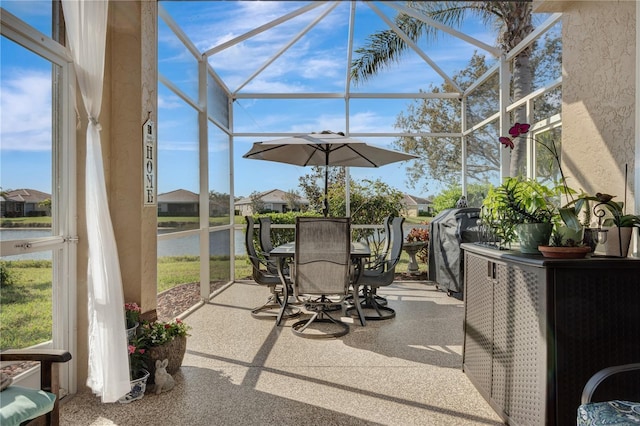 exterior space featuring a water view, a lanai, and outdoor dining space