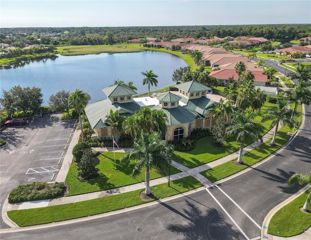 drone / aerial view featuring a residential view and a water view