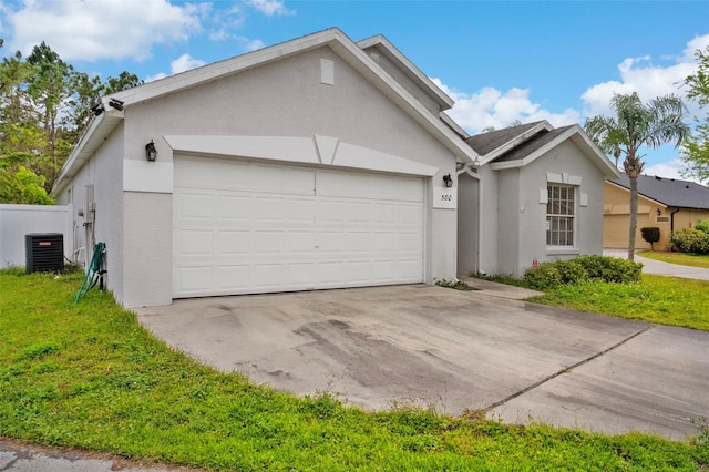 view of front of property with cooling unit, stucco siding, concrete driveway, a front lawn, and a garage