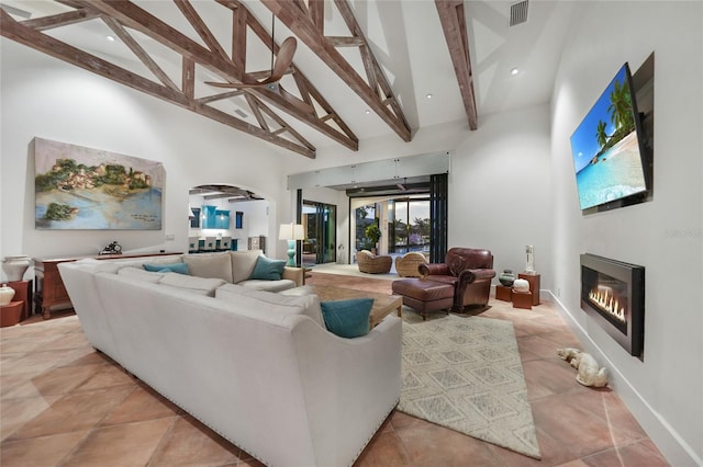 1111 San Mateo Dr, Punta Gorda, FL 33950 - living area with a glass covered fireplace, beam ceiling, visible vents, and high vaulted ceiling