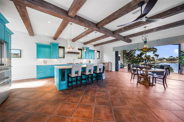 1111 San Mateo Dr, Punta Gorda, FL 33950 - kitchen with ceiling fan, a breakfast bar, light countertops, blue cabinets, and a sink