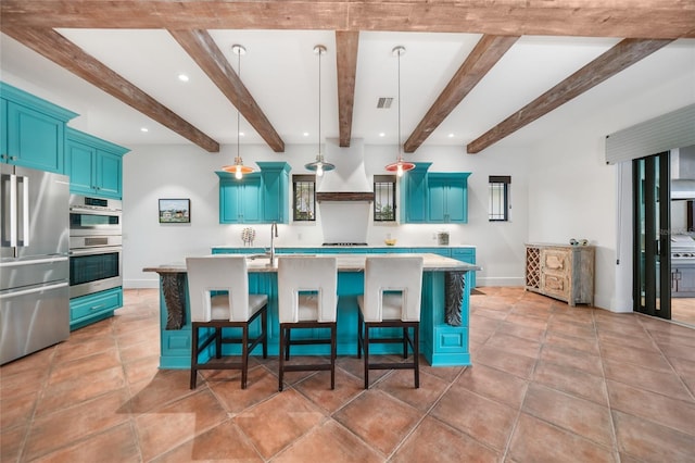 1111 San Mateo Dr, Punta Gorda, FL 33950 - kitchen with blue cabinetry, appliances with stainless steel finishes, light countertops, and a kitchen breakfast bar