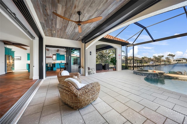 1111 San Mateo Dr, Punta Gorda, FL 33950 - view of patio / terrace with a lanai, a pool with connected hot tub, ceiling fan, and a water view