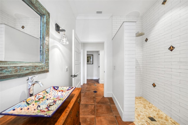 1111 San Mateo Dr, Punta Gorda, FL 33950 - full bath featuring vanity, visible vents, crown molding, walk in shower, and tile patterned floors