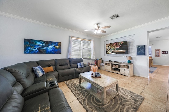 living area featuring light tile patterned floors, visible vents, a ceiling fan, and crown molding