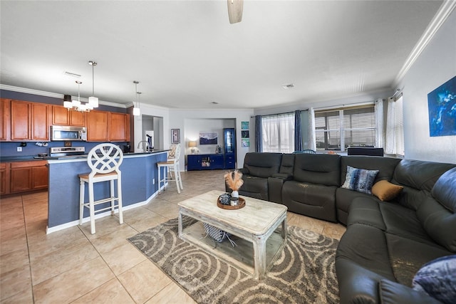 living area with crown molding, light tile patterned floors, ceiling fan with notable chandelier, and visible vents