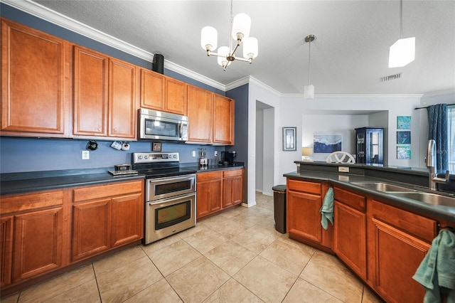 kitchen with dark countertops, visible vents, stainless steel appliances, and a sink