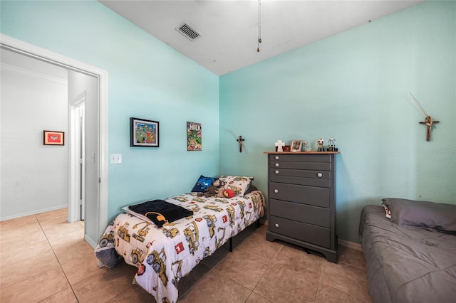 bedroom with tile patterned flooring, visible vents, and baseboards