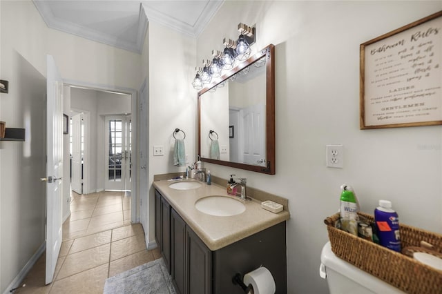 bathroom featuring a sink, toilet, ornamental molding, and double vanity