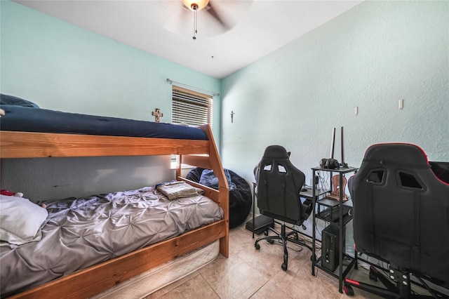 tiled bedroom with a ceiling fan