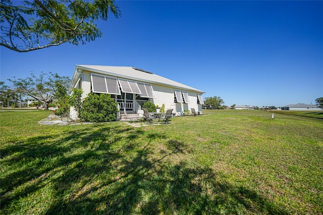 rear view of house with a yard