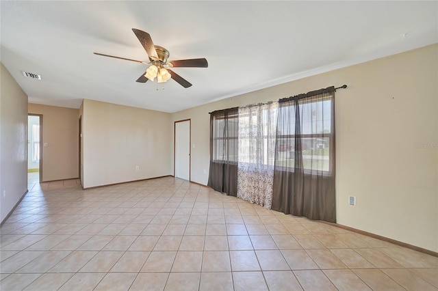 unfurnished room with light tile patterned floors, visible vents, and ceiling fan