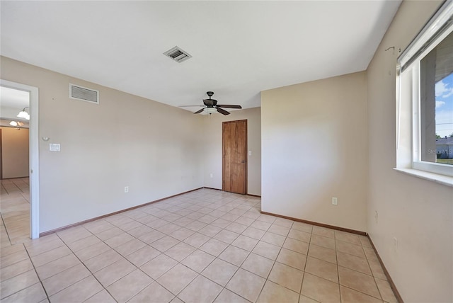 unfurnished room with visible vents, baseboards, and a ceiling fan