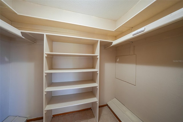 spacious closet with tile patterned floors