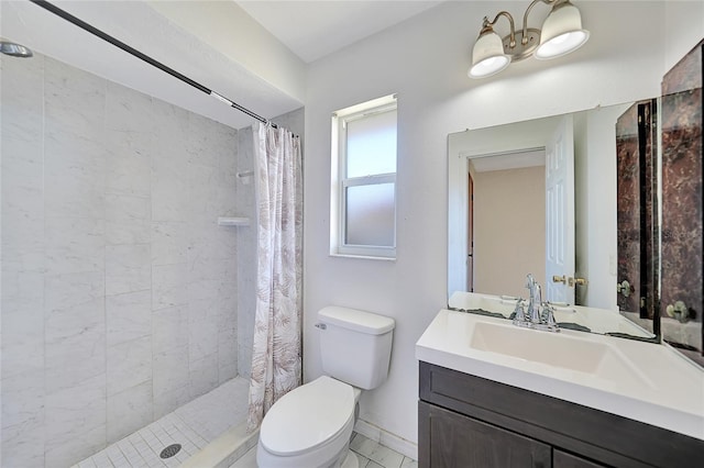 bathroom featuring vanity, toilet, baseboards, and a stall shower