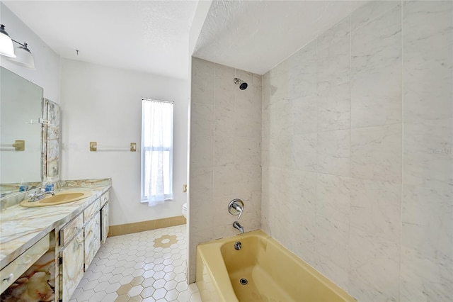 full bathroom featuring tile patterned floors, toilet, baseboards, bathtub / shower combination, and vanity