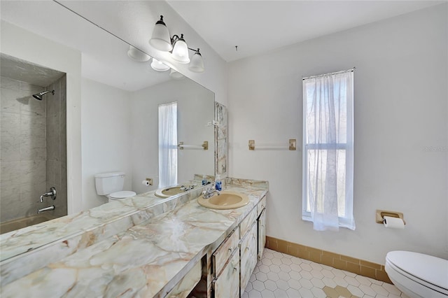 bathroom with vanity, tile patterned floors, toilet, and baseboards