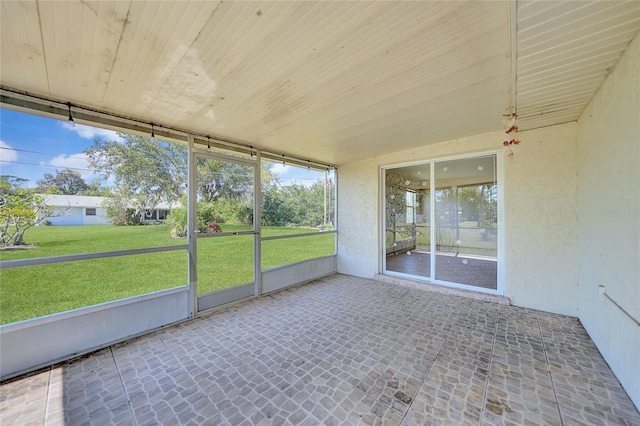 unfurnished sunroom with plenty of natural light and wood ceiling