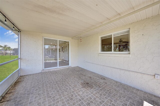 unfurnished sunroom featuring track lighting