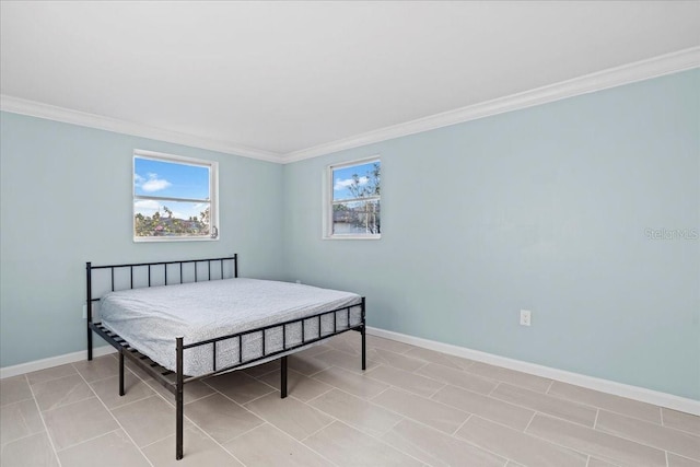 bedroom featuring light tile patterned floors, ornamental molding, and baseboards