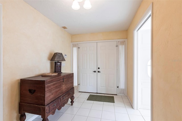 entryway featuring light tile patterned floors and visible vents