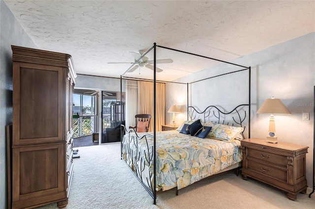 bedroom featuring ceiling fan, access to exterior, light colored carpet, and a textured ceiling