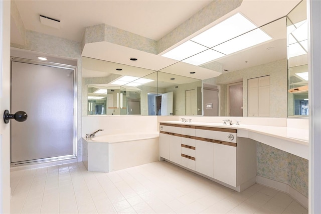 bathroom with vanity, a shower stall, and a bath