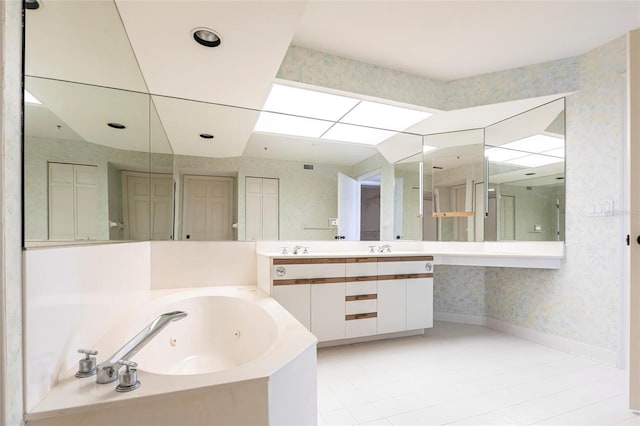 bathroom with vanity, baseboards, wallpapered walls, a whirlpool tub, and a closet