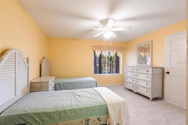 bedroom featuring a ceiling fan and light colored carpet