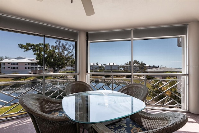 sunroom featuring a ceiling fan