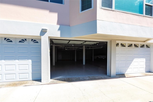 garage featuring concrete driveway