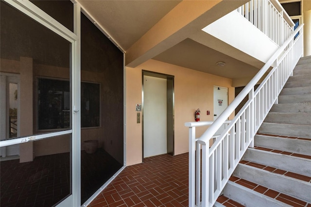 stairs featuring brick floor